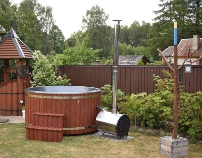Outdoor fiberglass tub with wood finish and external oven